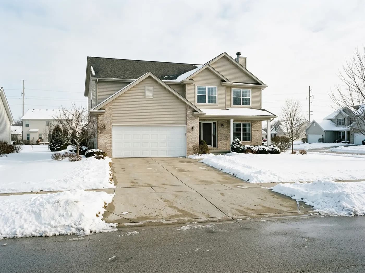 A wide concrete driveway at a newer Roscoe, Illinois subdivision home, cleared after a storm